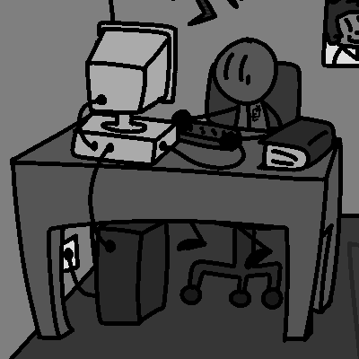 a grey kid sitting at a desk and using the computer.